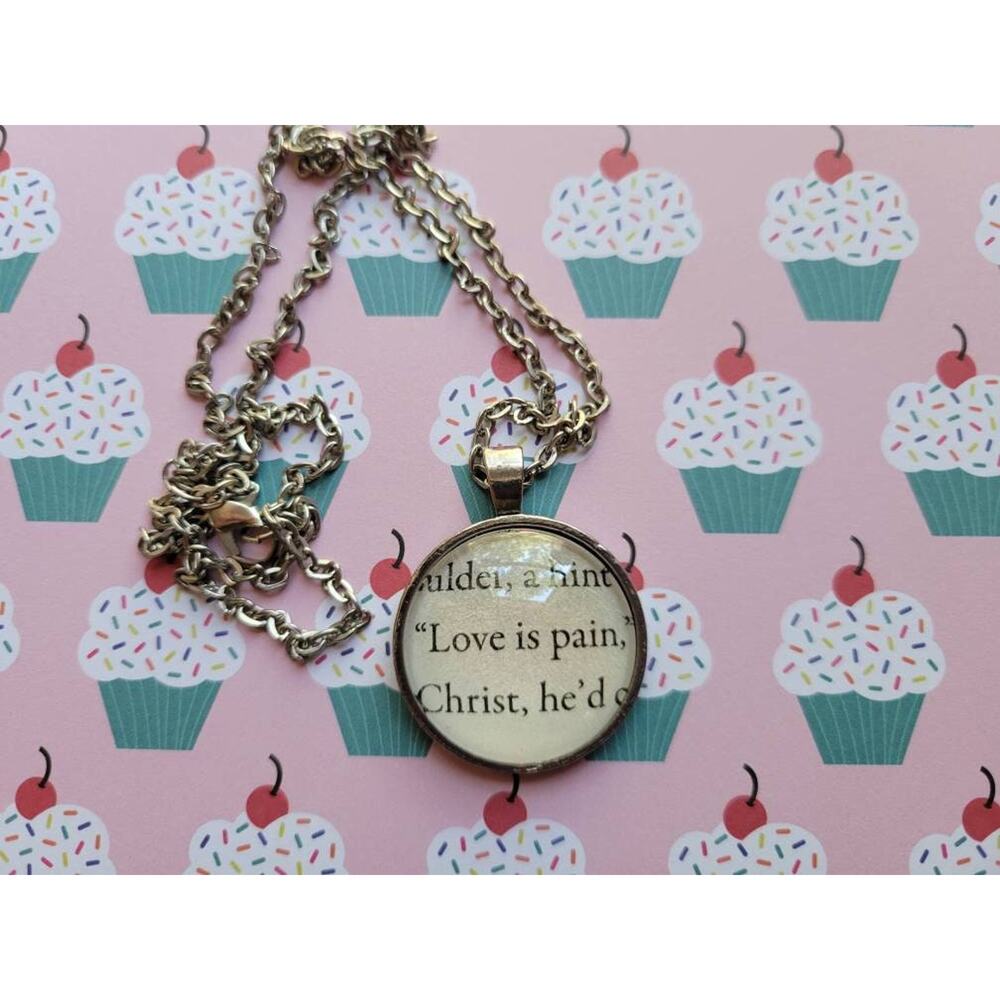 Love is Pain pendant necklace made from The Kiss Curse book pages